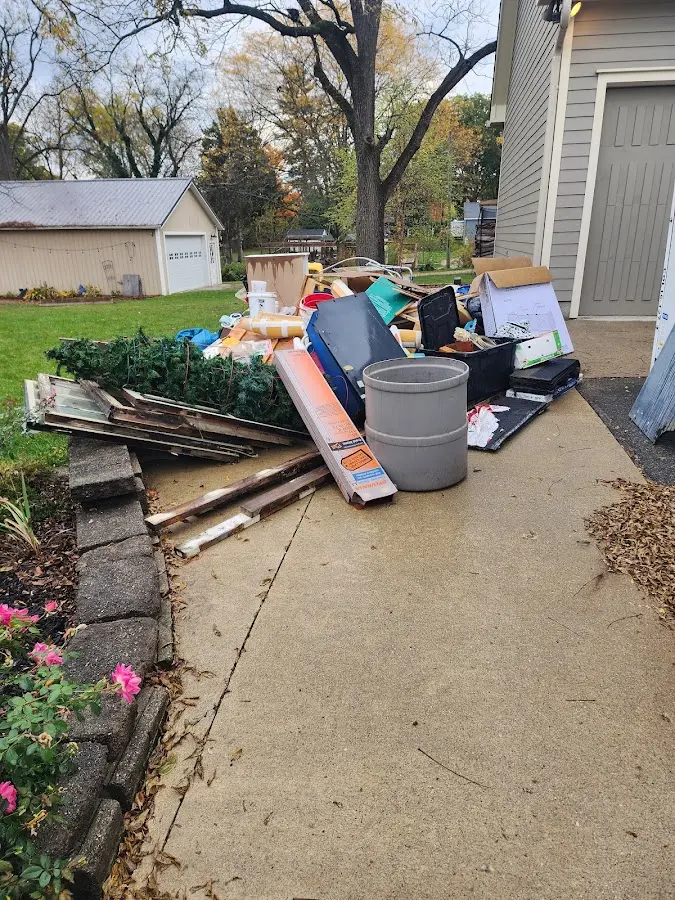 Dumpster being loaded with debris for 3 Yard Dumpster Rental in Balch Springs